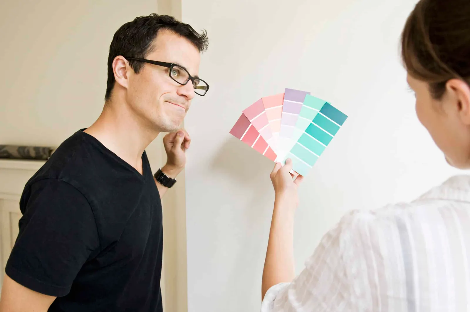 A color consultant showing paint swatches to a homeowner