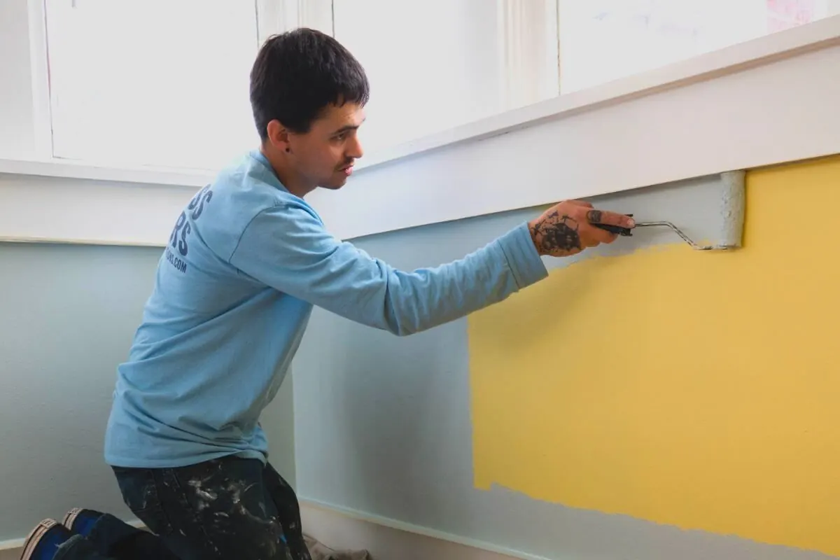 A Kind Home painter hand-detailing interior trim